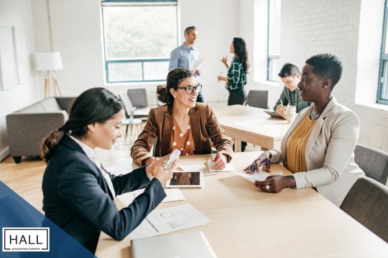 Diverse professionals collaborating in a modern office, showcasing teamwork and expertise in financial planning and strategic tax planning.