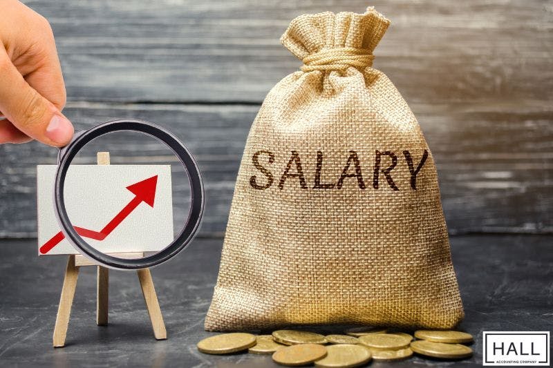 A salary bag, coins, and a rising graph symbolizing tax deductions and paycheck withholdings in taxation