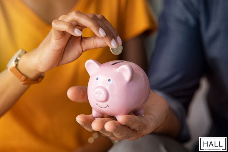 Saving money in a piggy bank symbolising smart accounting costs for small business budgeting