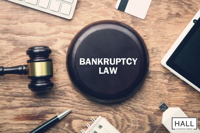 A wooden gavel rests on a sound block with the words