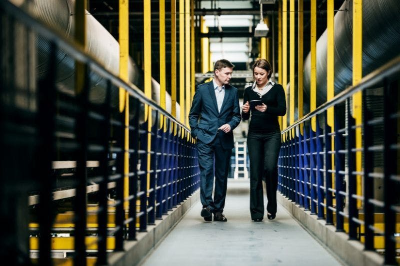 Female CFO discussing business strategy with male business owner in dallas