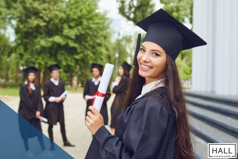 A graduate holding a diploma, symbolizing financial planning for the future of Texas state tax in 2025