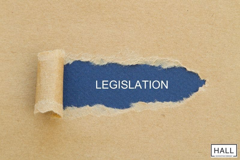 A torn piece of brown paper reveals the word