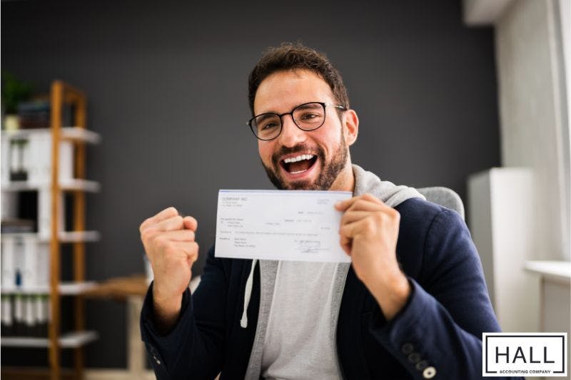 An employee in jubilation after correcting payroll errors