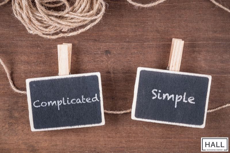 Two small black chalkboards hanging from a piece of twine by clothespins.