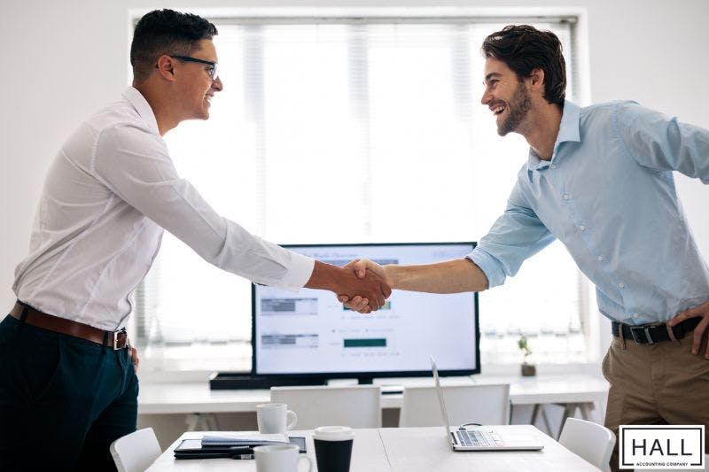 Business owner shaking hands with accountant, illustrating how to find accountant for small business