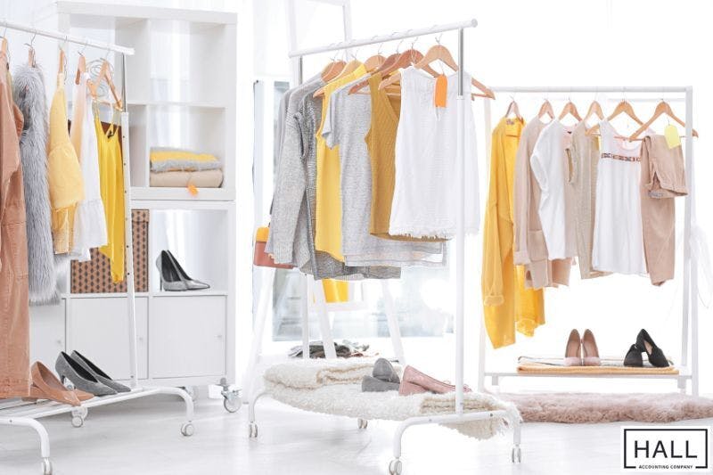 A clothing room filled with racks of clothes.