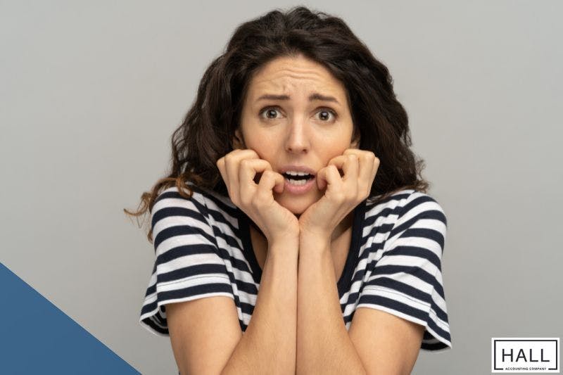 Concerned woman reacting to tax mistakes, illustrating the penalty for filing wrong income tax return in a financial guide