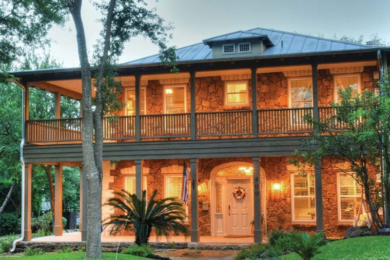 Two-story stone house in San Antonio, symbolizing property tax rate in san antonio tx.