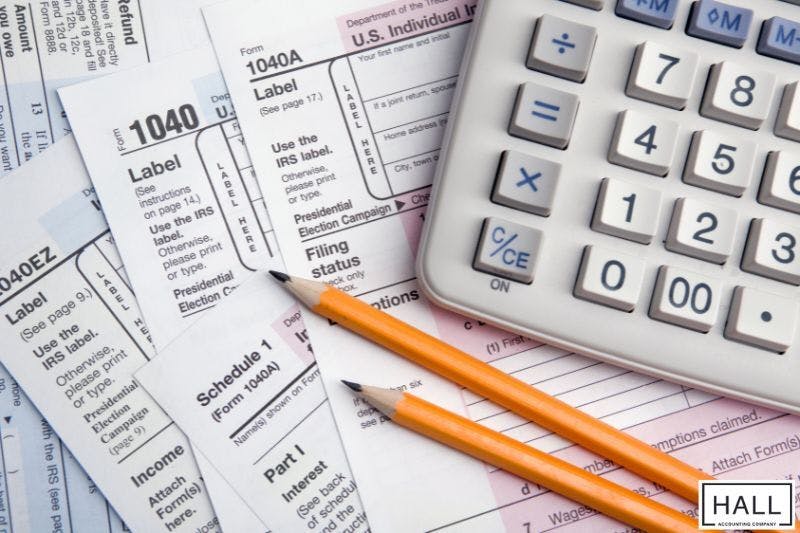 Tax forms, calculator, and pencils symbolising sales tax in San Antonio, Texas calculations.