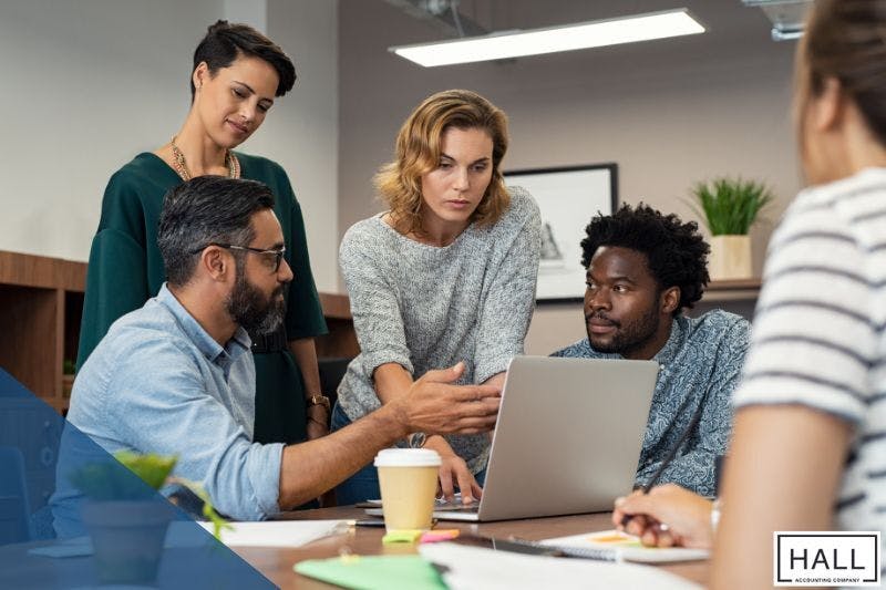 Team discussing tax planning strategies for individuals in 2025, focusing on maximizing savings and reducing tax liabilities