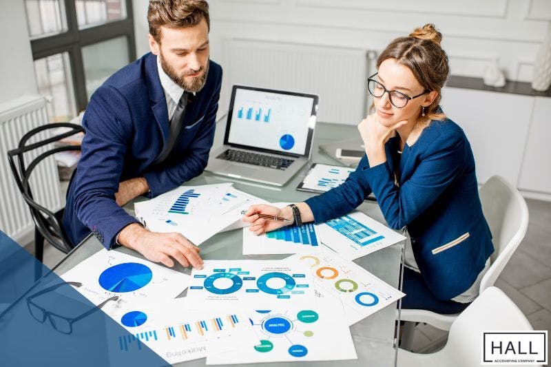 Two professionals analyzing financial charts to develop effective tax planning strategies for individuals in 2025