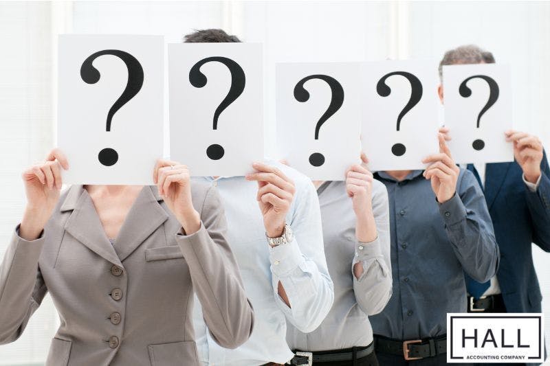 people holding chats with question marks symbol depicting trial balance common mystery errors