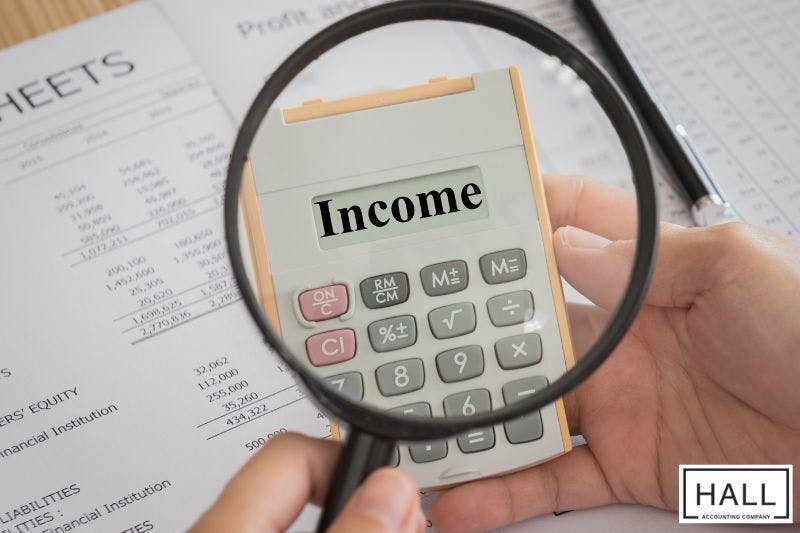 Business owner using Calculator to figure withholding allowances